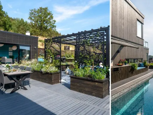 Modern villa med pool i sluttning. Uteplats med matbord och loungegrupp. Pergola med blommor.